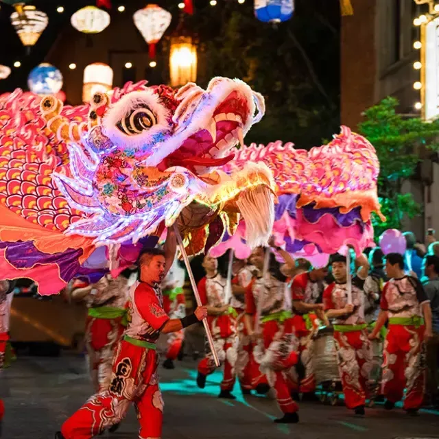 Dancers manipulate a giant, illuminated dragon during 贝博体彩app's Lunar New Year Parade.